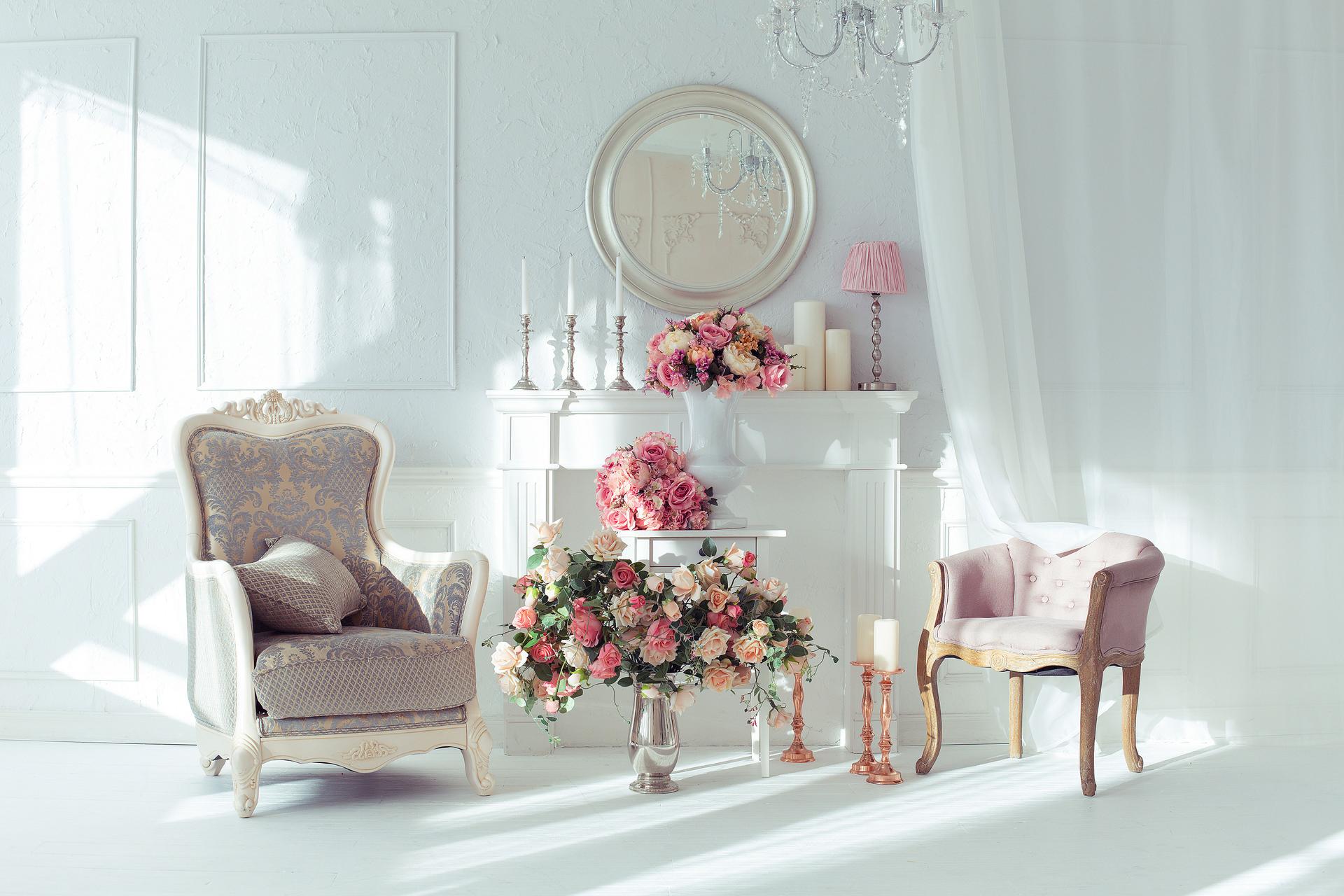 luxury clean bright white interior. a spacious room with sunlight and flowers in vases